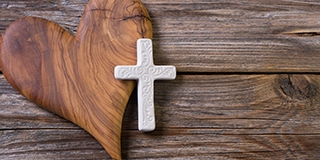 Wooden background - olive heart and white cross