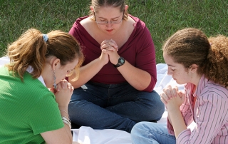 youth praying in a circle