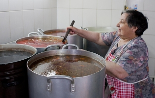 woman making soup in soup kitchen