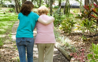 helping an elderly person walk